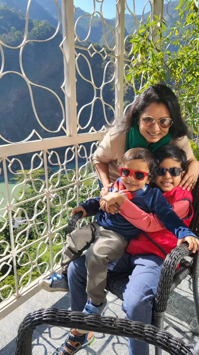 happy mother and two sons, sunglasses, greenery